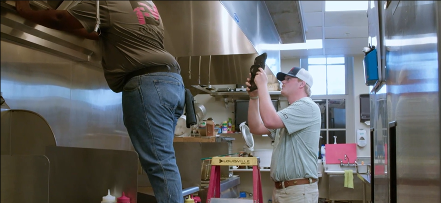 Brendle McGough technician inspecting a commercial kitchen fire suppression system